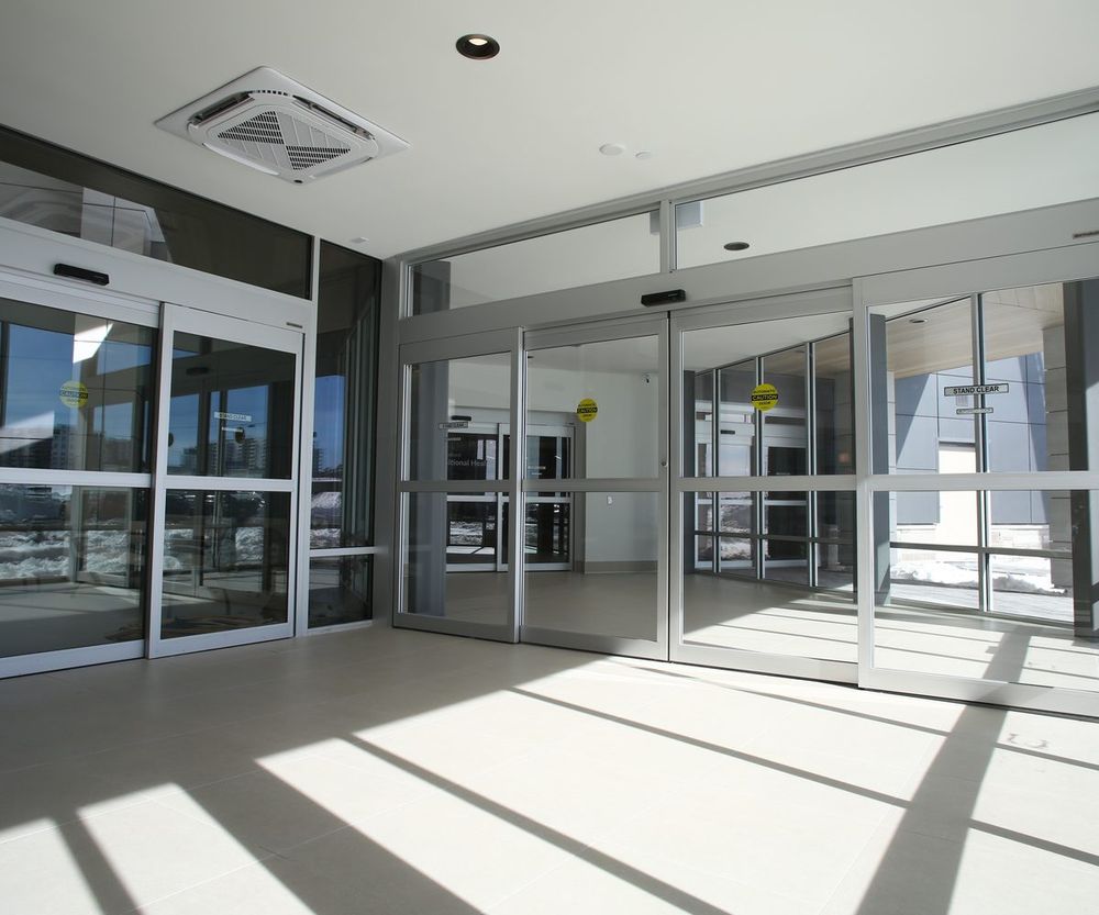 Aluminum-framed automatic sliding entrance doors installed in a commercial vestibule
